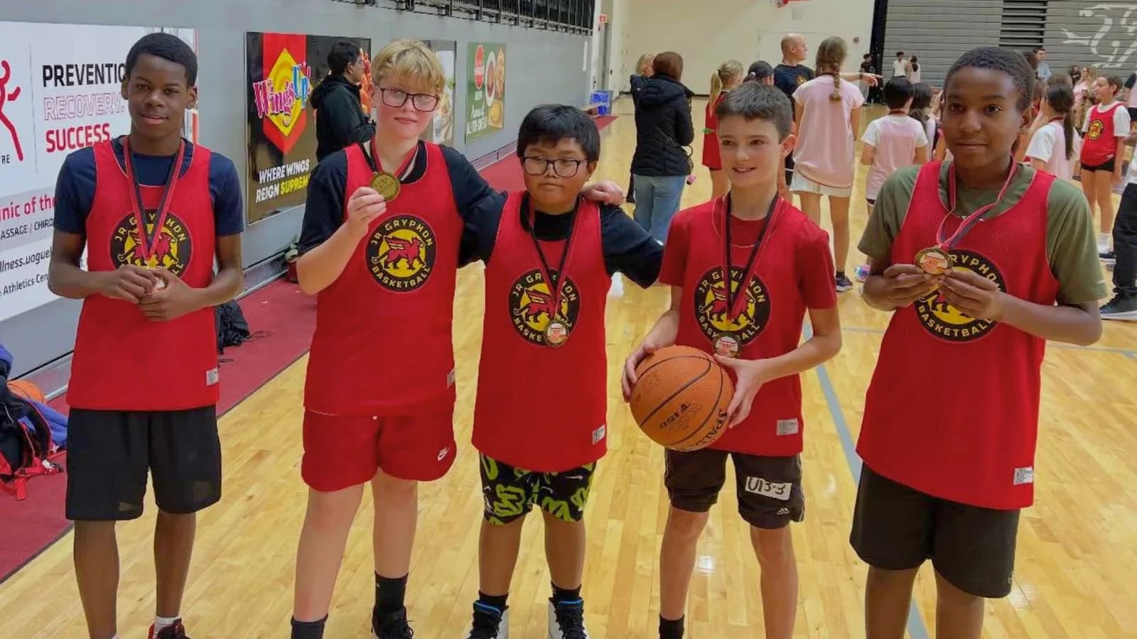 Junior Gryphons players wearing medals after a game