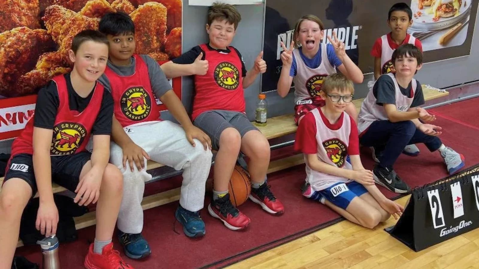 Junior Gryphons House League players celebrating on the bench